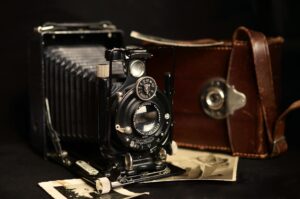 Close-up of an antique Voigtlander camera with a leather case, showcasing vintage photography equipment.